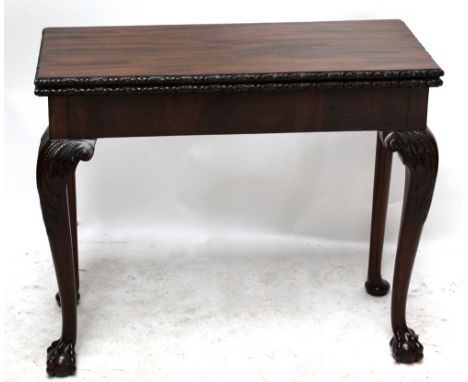 A 19th century and later mahogany card table with carved rim and carved cabriole front legs to ball and claw feet, the rear l