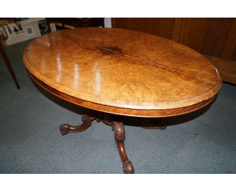 Victorian figured walnut tilt-top table, moulded top over over a bulbous pedestal, scrolled legs terminating on pot castors, 