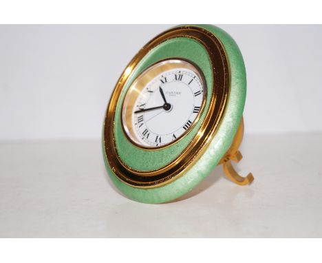 Cartier alarm clock, Lime lacquer (front) and gilt metal oval frame. Numbered 7509 15271. The back has two synthetic sapphire