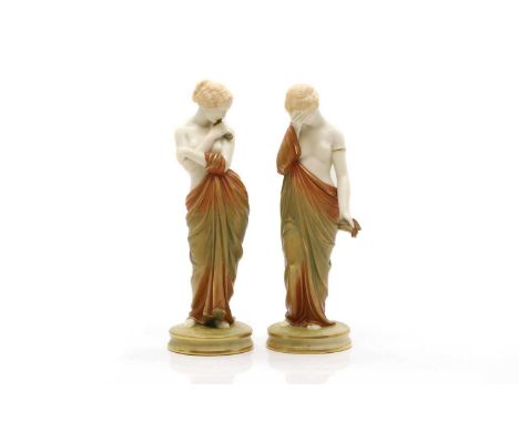 A pair of Royal Worcester biscuit glazed figures  1896, Joy and Sorrow, printed and impressed marks,  20cm high together with