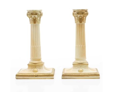 A pair or Royal Worcester porcelain candelabra, c.1920s, each modelled as a Corinthian column, with gilt detailing, stamped t