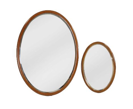 A graduated pair of wood mirrors,  of oval shape, with boxwood banding, and bevelled mirror plates, 78 x 53.5cm94.5cm x 124.5