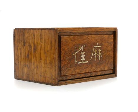 A cased Chinese mahjong set,  20th century, the sliding front enclosing five drawers, bamboo and bone counters and 'Rules and