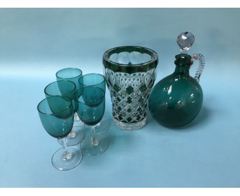 A green glass decanter, five glasses and a flashed green glass vase