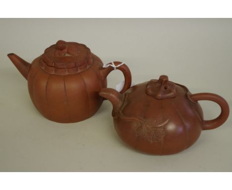 Two Chinese yixing melon form teapots and covers, late Qing, one with seal mark to base, largest 11.5cm high. (2) 