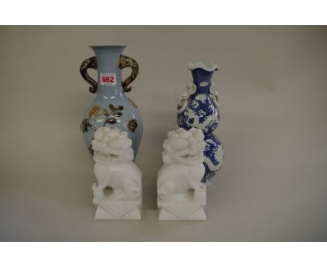 A Chinese twin handled blue and white double gourd vase, Qianlong moulded seal mark, relief decorated with dragons and a phoe