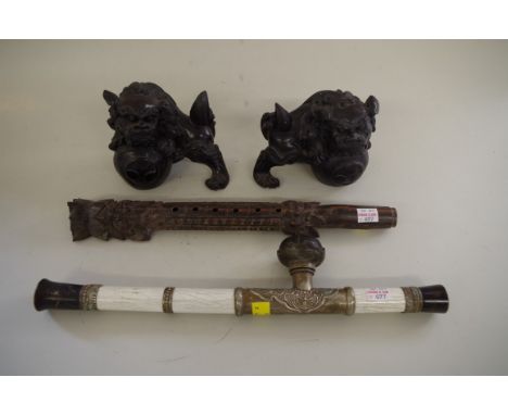 A pair of Chinese carved hardwood dogs of fo, 12cm high; together with a Chinese opium pipe; and a carved rosewood flute, 36.