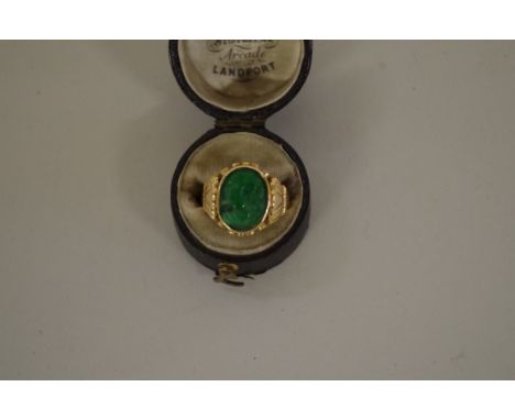 A Chinese yellow metal and green jade cameo ring. 
