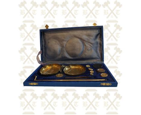 Boxed set of brass balance scales weighing up to 100 grams.  Made in India.