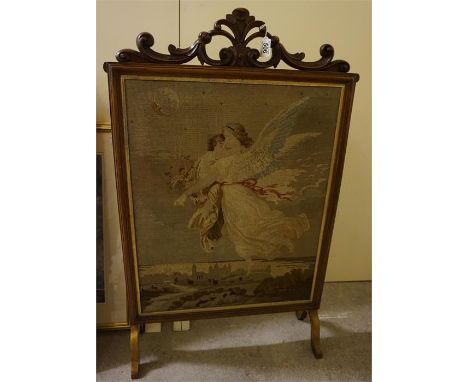 A Victorian walnut fire screen with a tapestry insert 