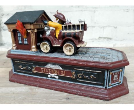 A cast metal money bank formed as a fire engine and bank.  