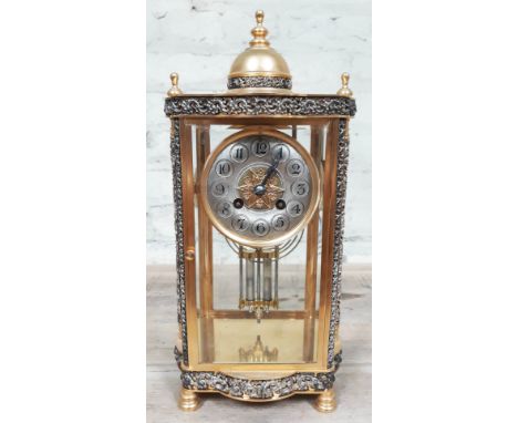 A French four glass brass mantel clock with pierced folliate bands and pillars, the movement striking on single coil, with me