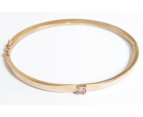 A hallmarked 9ct gold bangle set with a single 0.10 carat diamond, diam. approx. 5cm, gross weight 12.4g.  Condition - good, 