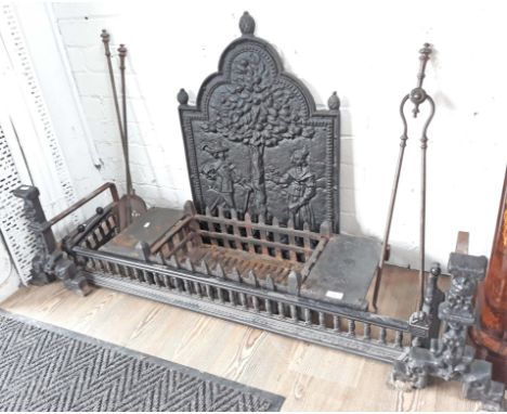 Various fireplace items comprising a cast iron back plate, grate, fender, a pair of dogs and tools.  