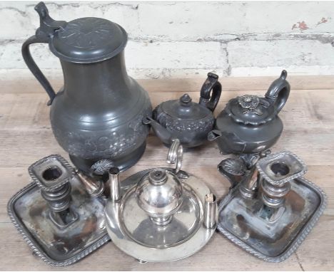 A mixed lot of metalware comprising two pewter teapots, a pewter flagon, a silver plated table lighter, a pair of Sheffield p