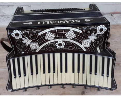 An Italian Scandalli accordion, curved keyboard with 7 couplers, inscribed '5039 Camerano Italia' to reverse.