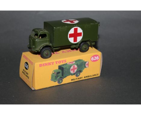 A Dinky military ambulance (626), olive-drab, with driver and no windows, displayed in reproduction cardboard box. 