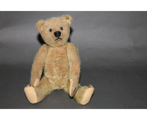 An early 20th-century Steiff teddy bear, with "FF" button to its ear, having light brown short pile mohair covered body, with