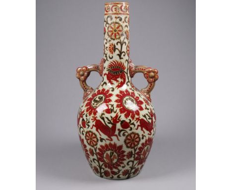 An early 20th century Zsolnay vase - of Persian pattern with twin handles and decorated with beasts and foliage, height 28cm