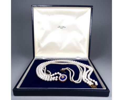 A three string pearl necklace - of uniform beads with a blue enamel and gilt star oval clasp, length 40cm, together with anot