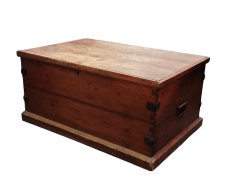 A late 19th century pine trunk - with steel binding and carrying handles, the rectangular hinged lid revealing a void interio