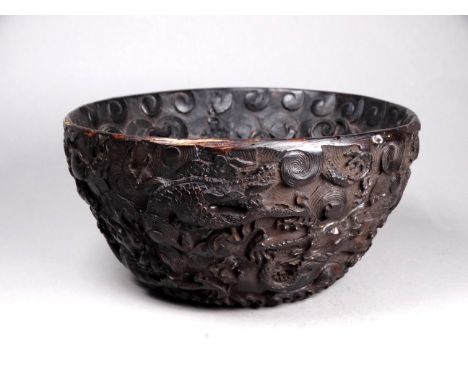 A Chinese bowl - the relief decoration showing dragons chasing a flaming pearl, diam. 15cm