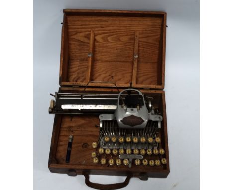A late 19th century Blickensderfer aluminium featherweight typewriter - Serial No.147020, in wooden carrying case. 
