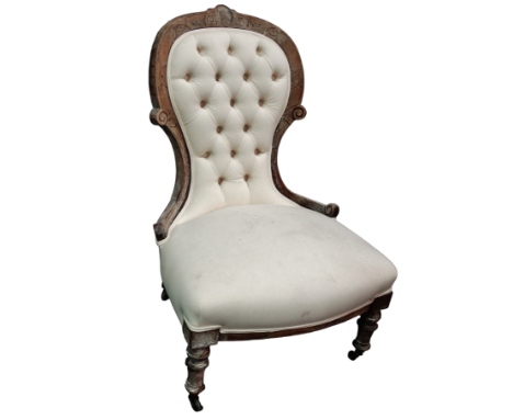 A late Victorian button upholstered spoon back chair - the walnut frame with cream cotton upholstery.