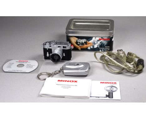 A Minox digital camera - in the form of a miniature Leica M3, together with another miniature digital camera. 
