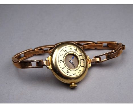 An early 20th century 18ct yellow gold ladies wristwatch - the cream dial set out in Arabic numerals in blue enamel on a yell
