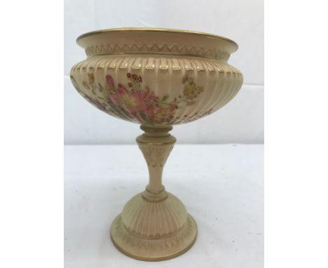 A Royal Worcester comport with floral designs on blush ivory ground on a stepped base: H21.5cm