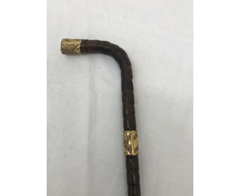 An Edwardian 18ct gold-plated malacca walking stick presented to M K Johnson, Dec 1, 1905