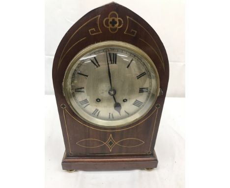 A large arch mahogany mantel clock with quatrefoil brass inlay striking on two gongs