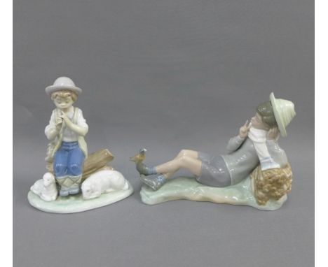 Lladro figure of a boy with a bird perched on his foot, 23cm long,  and a Nao figure, (2) 