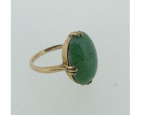 An oval cabochon jade Ring,&nbsp;claw set in unmarked yellow metal, tests as 9ct, Size K½, approx total weight 3.8g. 