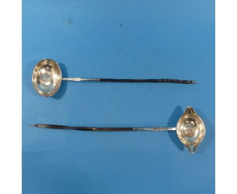 A George II silver Toddy Ladle,&nbsp;with twisted whalebone handle, the centre inset with a sixpence, dated 1737, initialled,