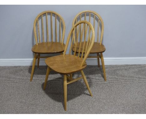 Three Ercol 'Blonde' ash and elm Windsor Chairs, with hoop and stick back, also sticker labels 17in (43cm) wide x 17in (43cm)