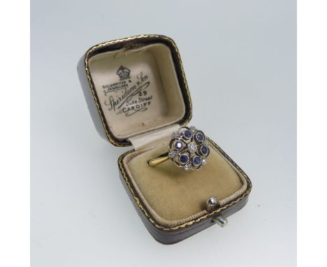 An early 20thC sapphire and diamond Dress Ring,&nbsp;the open circular front with central diamond surrounded by five sapphire