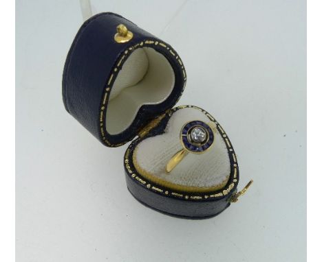 A small sapphire and diamond Dress Ring, with calibre cut sapphires and with a central diamond, all mounted in 18ct yellow an