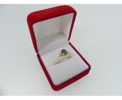 A sapphire and diamond Ring, the sapphire with three diamonds on each shoulder,&nbsp;one missing,&nbsp;all mounted in 18k yel