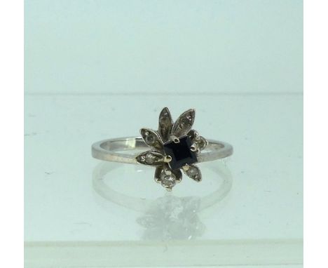 A small sapphire and diamond Dress Ring,&nbsp;of abstract flowerhead form, all mounted in 18ct white gold, Size M½, approx to