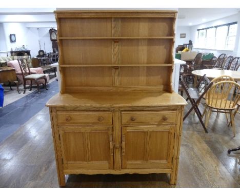 A vintage Ercol Dresser, design 453, with plate rack above two drawers and doors, with sticker label to back and seal stamp, 