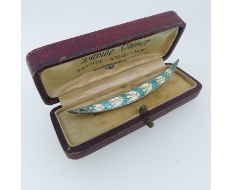 A sterling silver and enamel Brooch,&nbsp;the crescent shaped brooch enamelled with graduating white fish, 3in (7.5cm) long, 