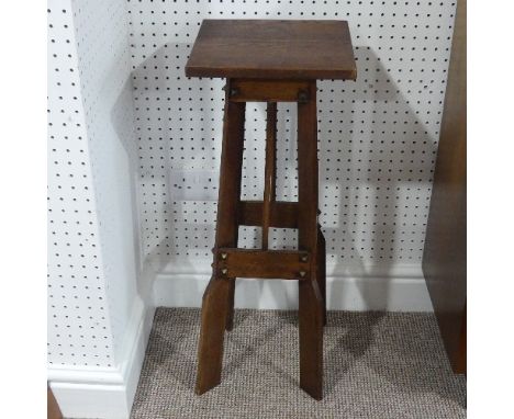 An Arts and Crafts oak Torchere Plant Stand, of architectural form, 12in (30cm) wide x 12in (30cm) deep x 32in (81cm) high. 