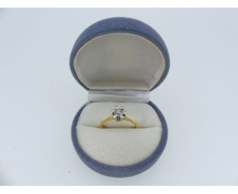 A single stone Diamond Ring, the circular cut stone c¼ct, in white and yellow gold marked 750, Size N, approx total weight 4.