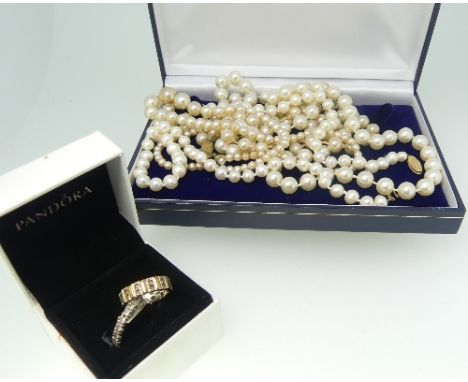 Four strings of Cultured and Faux Pearls, together with a 9ct white and yellow gold eternity ring set white pastes, Size K, 5