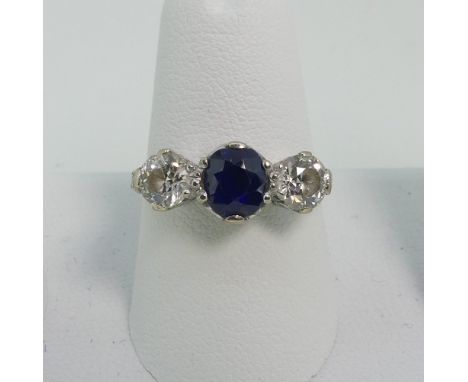 A three stone sapphire and Diamond Ring, the central sapphire c.¾ct with a brilliant cut diamond on either side, each approx.