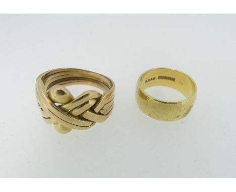 A 14k yellow gold Ring, of Greek puzzle style, Size M, 11g, together with an 18ct yellow gold band, Size L, 7.1g (2) 