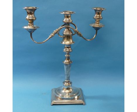 A silver plated three light Candelabra, the scroll arms detachable to leave a single central light, on square base, 16in (42c