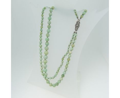 A double row of early 20thC graduated pale jade Beads, on a white paste snap. 